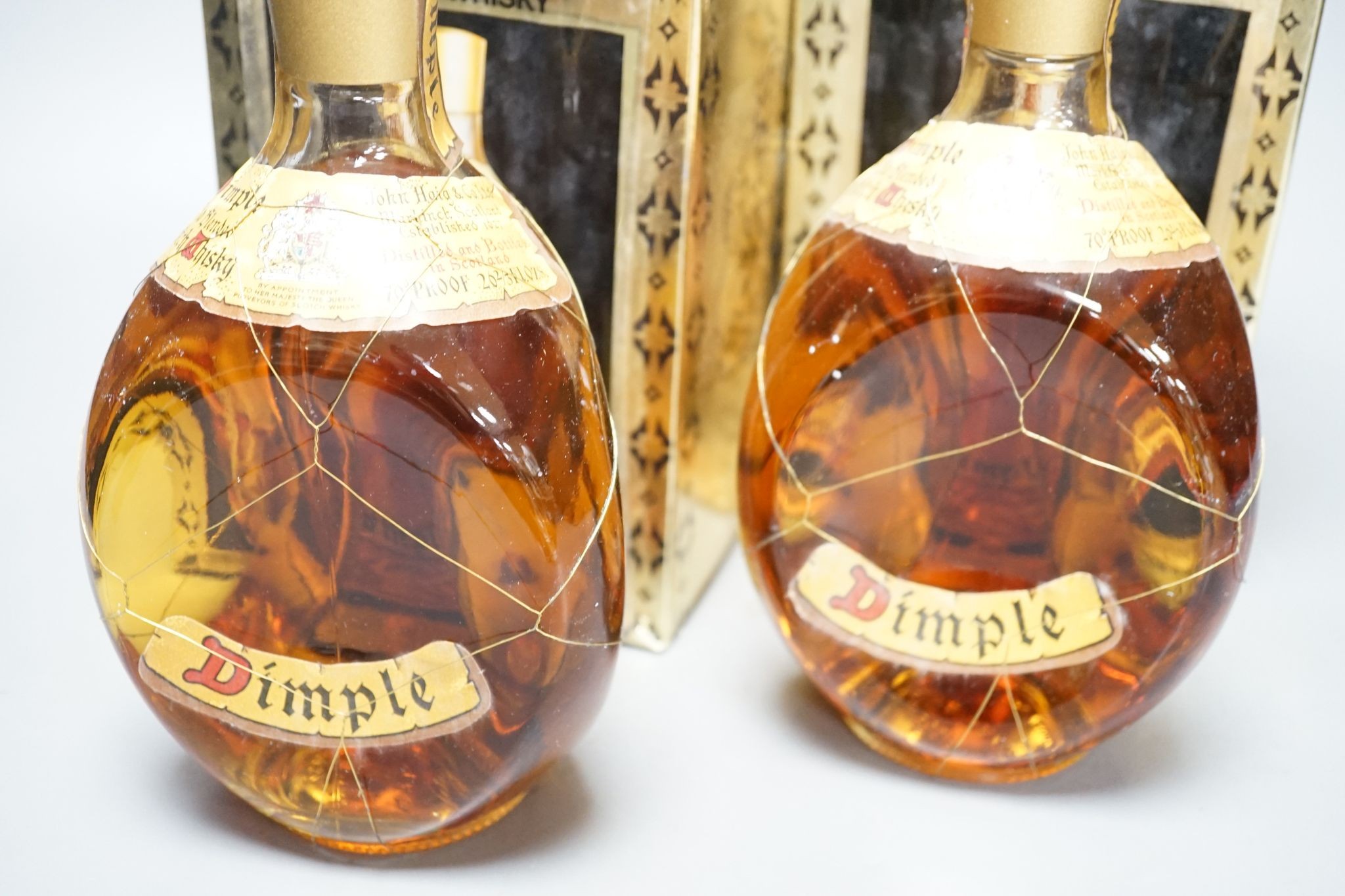 Two boxed bottles of Dimple Scotch whisky.